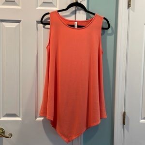 Sleeveless, high/low coral top. NWT. Size Medium. Very soft fabric.